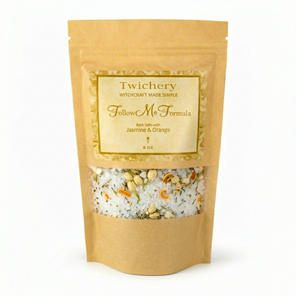 Kraft paper pouch of Twichery Follow Me Formula Bath Salts on a white background, with herbal bath salts visible through the window and a golden label displaying the Twichery Authenticity Sigil.