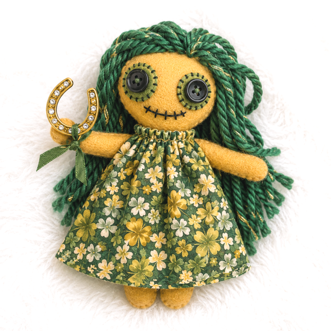 Hoodoo doll with green hair and four-leaf-clover dress holding a horseshoe on a white background