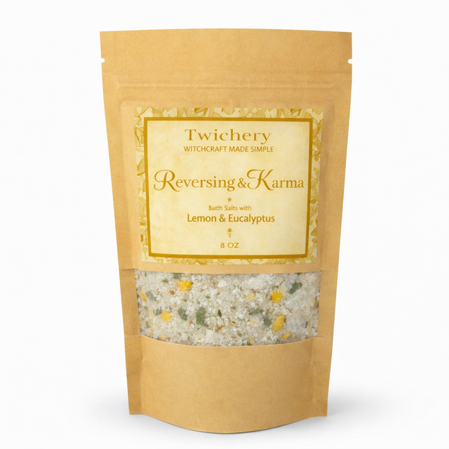 Kraft paper pouch of Twichery Reversing & Karma Bath Salts on a white background, with herbal bath salts visible through the window and a golden label displaying the Twichery Authenticity Sigil.