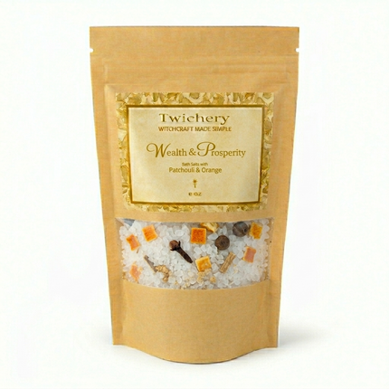 Kraft paper pouch of Twichery Wealth & Prosperity Bath Salts on a white background, with herbal bath salts visible through the window and a golden label displaying the Twichery Authenticity Sigil.