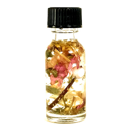 A small clear bottle with a black cap containing almond oil, essential oils, pink rose petals, a hawthorn thorn and various botanicals formulated for BDSM submission intentions.