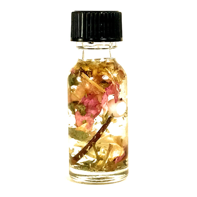 A small clear bottle with a black cap containing almond oil, essential oils, pink rose petals, a hawthorn thorn and various botanicals formulated for BDSM submission intentions.